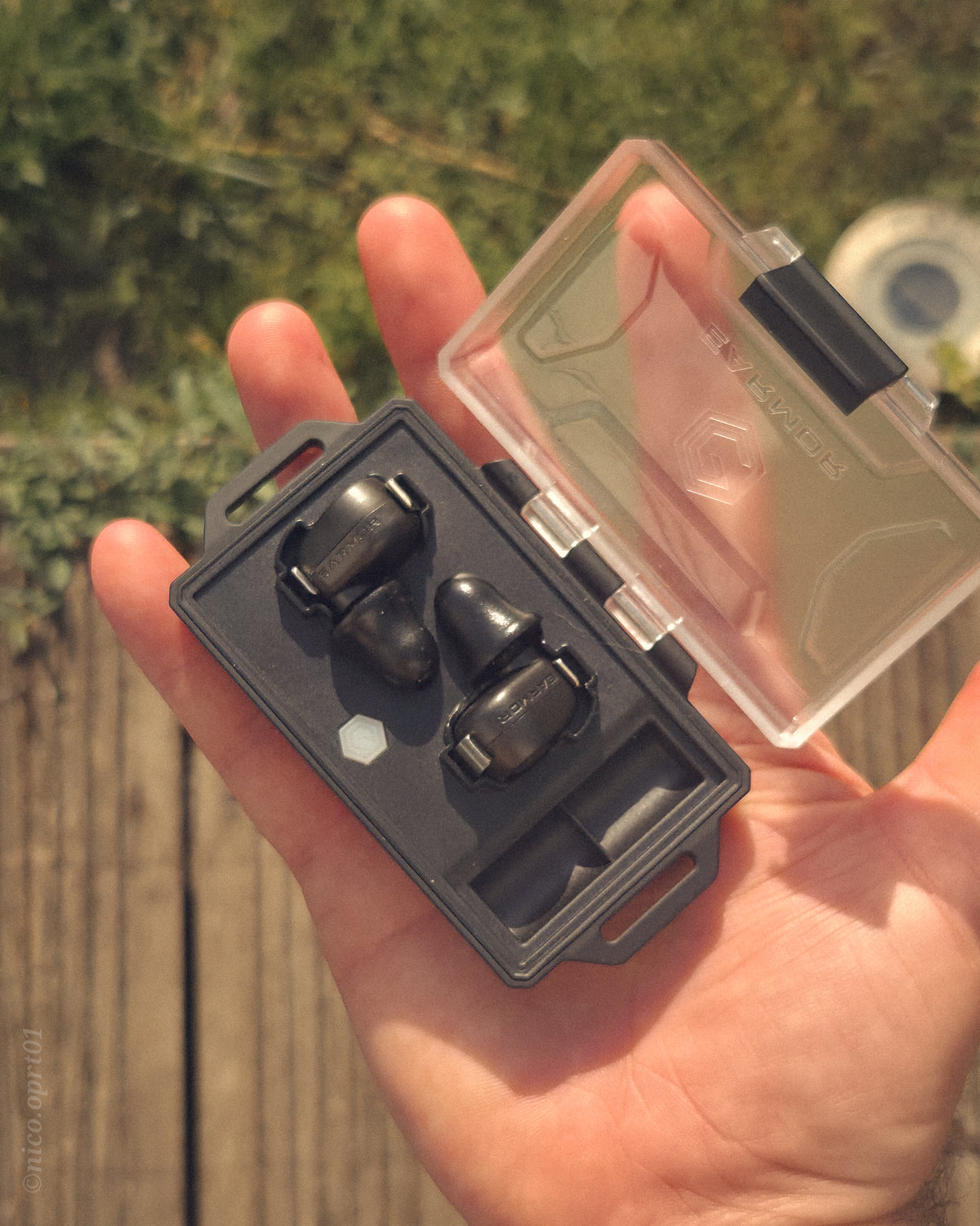 Man wearing EARMOR M20T PRO electronic earbud outdoors